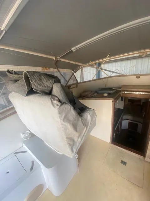 Slide: The Image of 1953 Rybovich Express boat interior with covered seating and cabin entrance. - 29