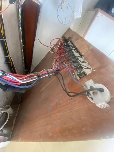 Slide: The Image of 1953 Rybovich Express boat wiring panel with exposed cables and connections. - 34