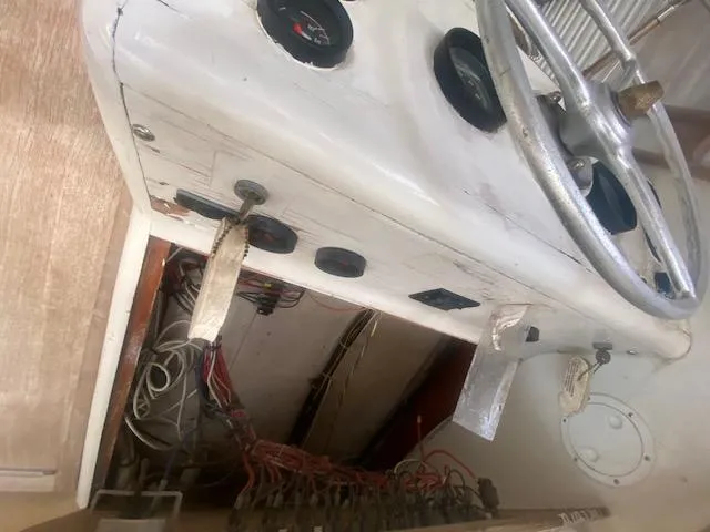 Slide: The Image of 1953 Rybovich Express boat dashboard with steering wheel and gauges. - 35