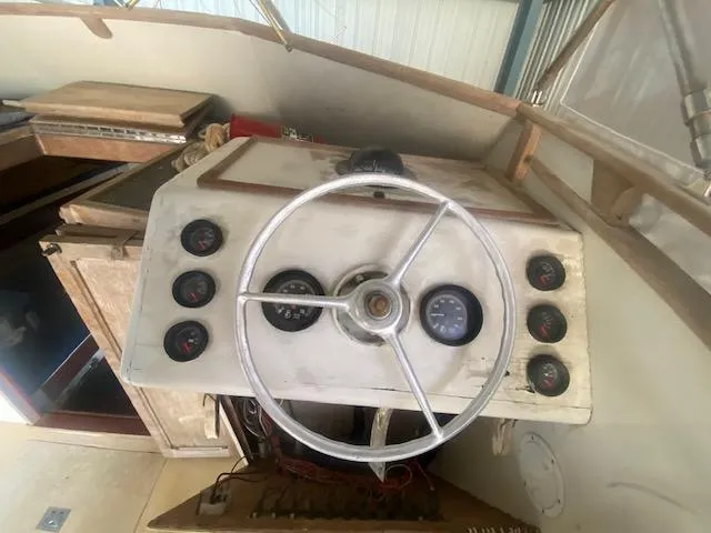 Slide: The Image of 1953 Rybovich Express boat dashboard with vintage steering wheel and gauges. - 36