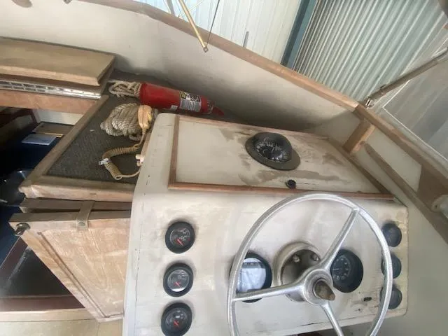 Slide: The Image of 1953 Rybovich Express boat interior with steering wheel and gauges. - 37