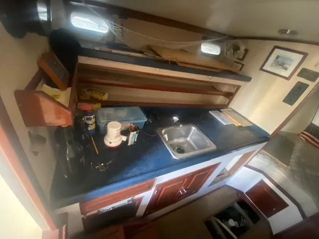 Slide: The Image of Interior of a 1953 Rybovich Express boat with a compact kitchen area. - 39
