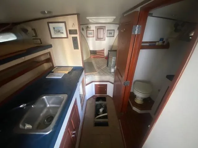 Slide: The Image of 1953 Rybovich Express boat interior with kitchenette, bed, and bathroom. - 40