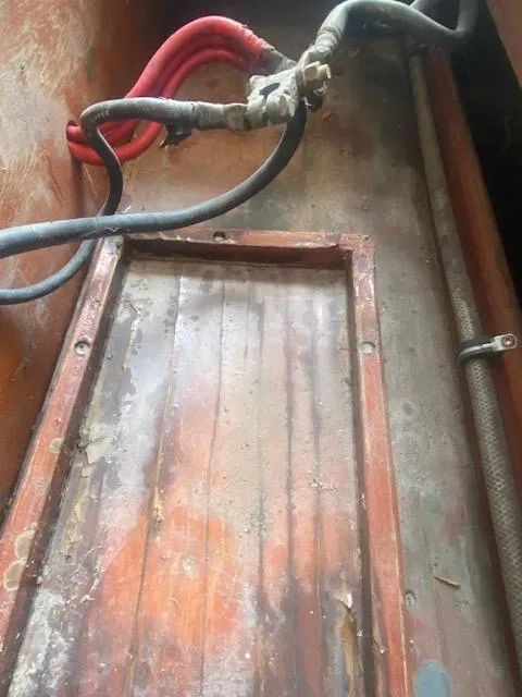 Slide: The Image of 1953 Rybovich Express boat interior with visible wiring and wooden paneling. - 43