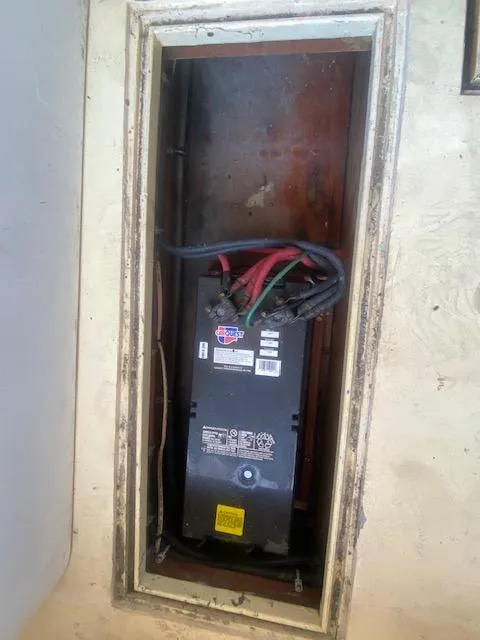 Slide: The Image of Battery compartment in a 1953 Rybovich Express boat, featuring wiring and connections. - 47