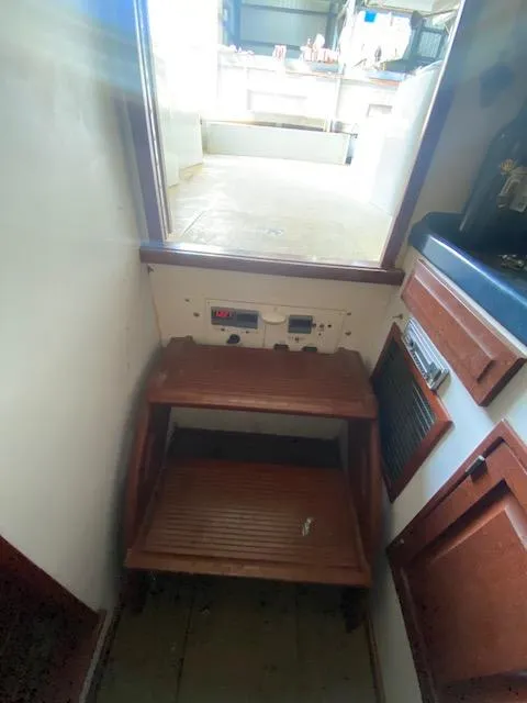 Slide: The Image of Interior of a 1953 Rybovich Express with wooden furniture and control panels. - 51