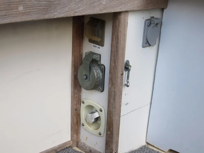 Slide: The Image of 1953 Rybovich Express boat electrical panel with various outlets and switches. - 9