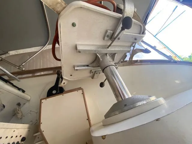 Slide: The Image of Close-up of a boat part with metal and plastic components, including a lever and a pipe. - 54