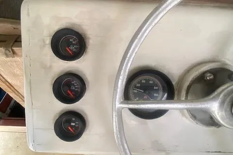 Slide: The Image of A classic dashboard with four round gauges and a silver steering wheel. - 58