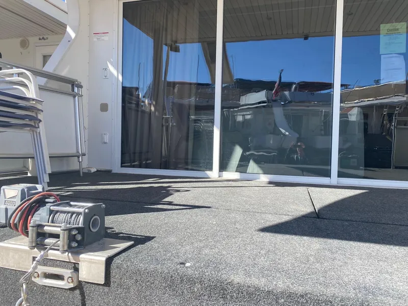 Slide: The Image of 2012 Bravada Ho'Okipa Trip #1 houseboat deck with winch and glass doors. - 3