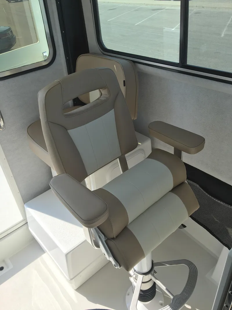 Slide: The Image of Captain's chair inside a 2023 Parker 2520 XLD Sport Cabin boat. - 3