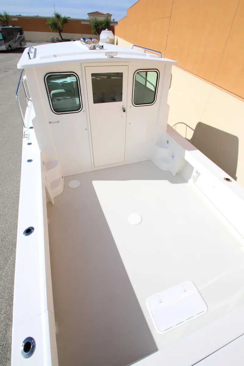 Slide: The Image of 2023 Parker 2520 XLD Sport Cabin boat with spacious deck and cabin. - 4
