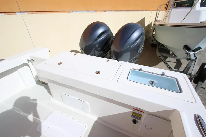 Slide: The Image of 2023 Parker 2520 XLD Sport Cabin boat with dual outboard motors. - 5