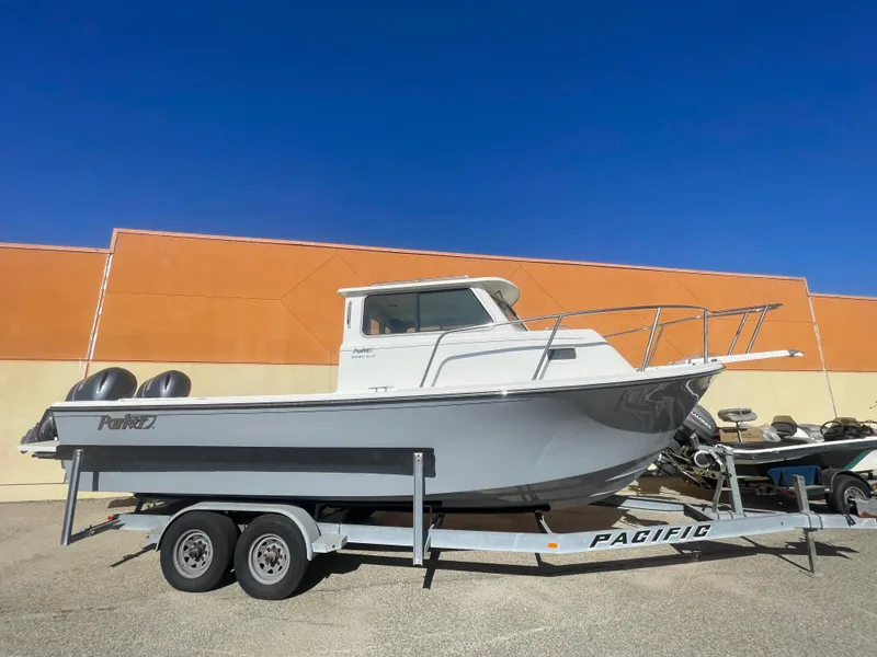 Slide: The Image of 2023 Parker 2520 XLD Sport Cabin boat on trailer, parked outdoors. - 7