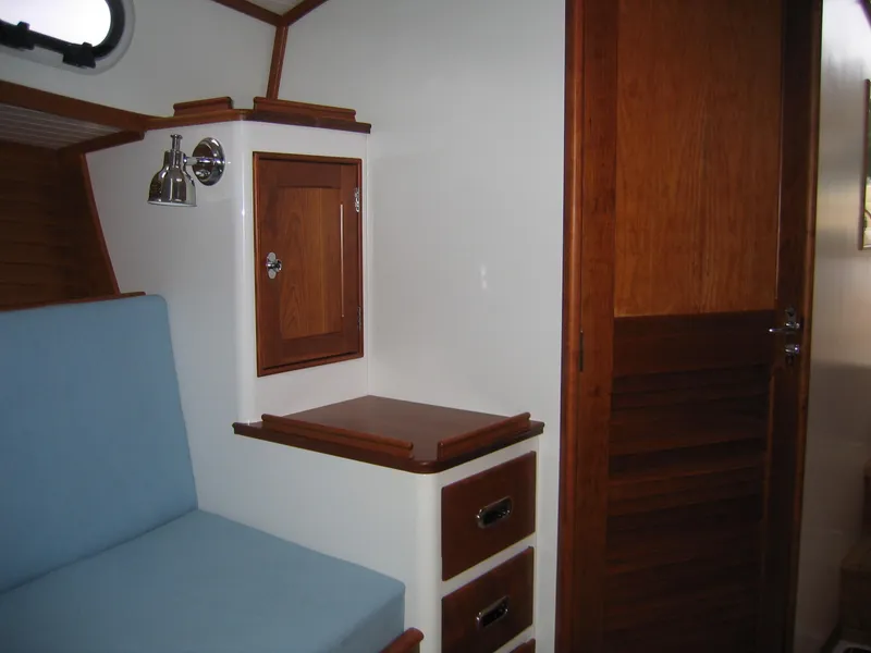 Slide: The Image of Interior of 2026 CH Marine Shelter Island Runabout with wooden cabinetry and blue seating. - 5