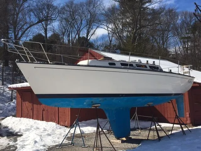 The Image of 1985 S2 9.1 sailboat on stands in a snowy yard. - 0