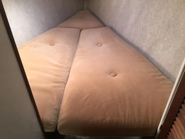 Slide: The Image of V-berth bed with beige cushions in 1985 S2 9.1 sailboat. - 14