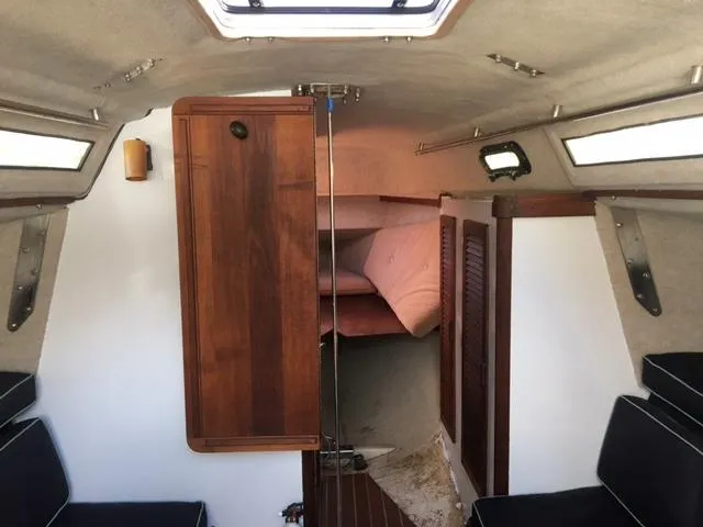 Slide: The Image of Interior of 1985 S2 9.1 sailboat with wooden cabinetry and seating. - 16
