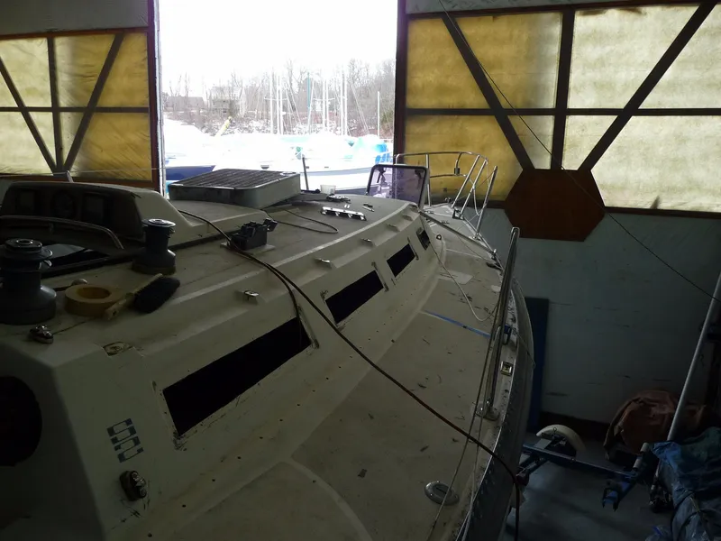 Slide: The Image of 1985 S2 9.1 sailboat in a storage facility, partially disassembled. - 19