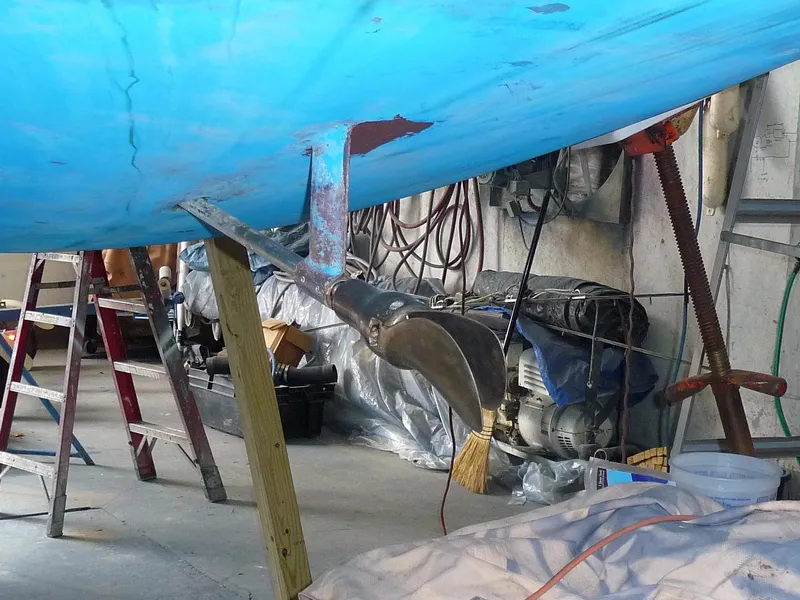 Slide: The Image of 1985 S2 9.1 sailboat undergoing maintenance in a workshop. - 25