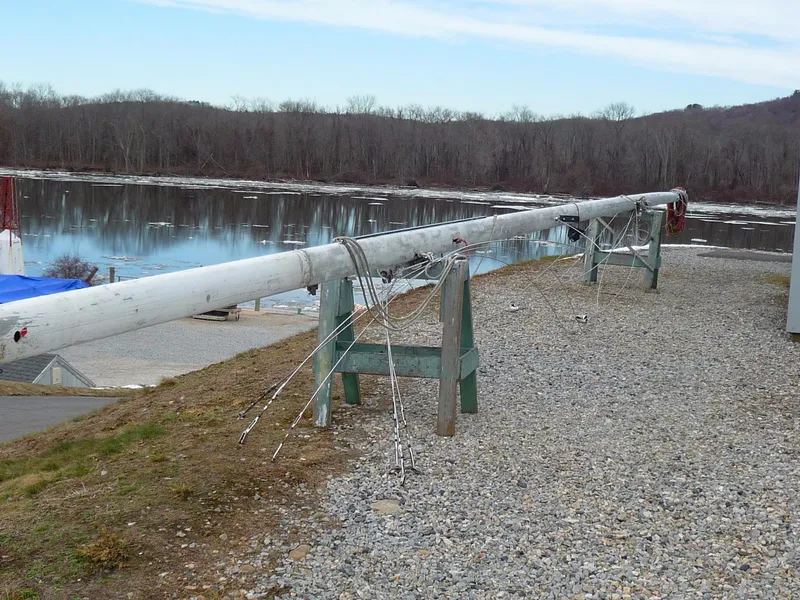 Slide: The Image of Sailboat mast from 1985 S2 9.1 model on stands by a lake. - 28