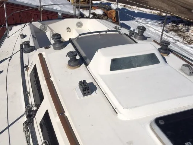 Slide: The Image of 1985 S2 9.1 sailboat deck with winches and hatches in snowy yard. - 3