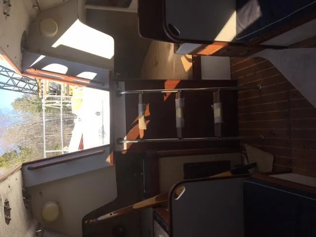 Slide: The Image of Interior of a 1985 S2 9.1 sailboat with wooden flooring and seating. - 5