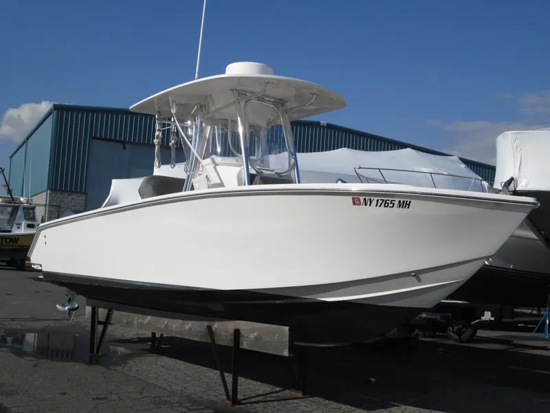 The Image of 2012 Jupiter 26 Forward Seating boat on display in a marina setting. - 0