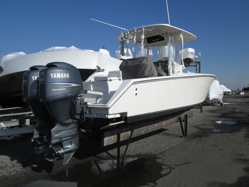 Slide: The Image of 2012 Jupiter 26 FS boat with twin Yamaha 200 engines on stands. - 1