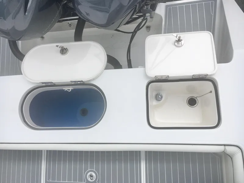 Slide: The Image of 2012 Jupiter 26 Forward Seating boat storage compartments with drawers and shelves. - 11