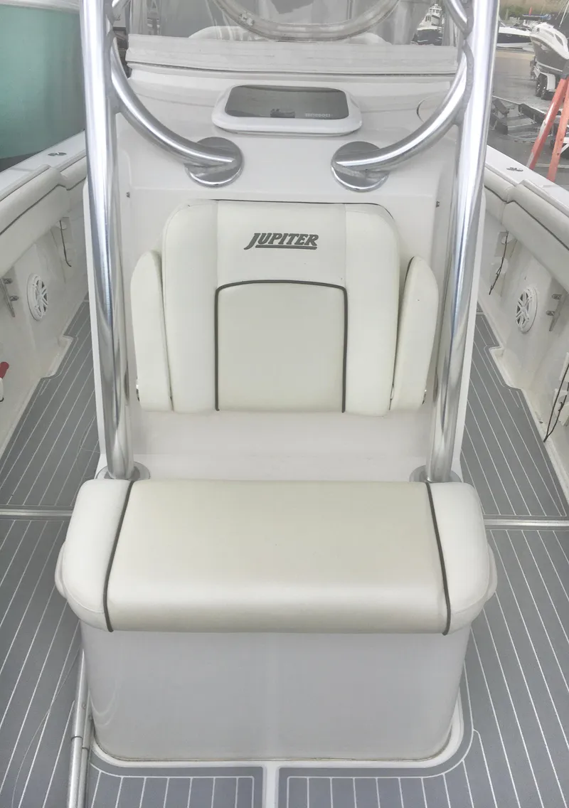 Slide: The Image of 2012 Jupiter 26 FS boat with twin Yamaha 200 engines, displayed outdoors. - 2