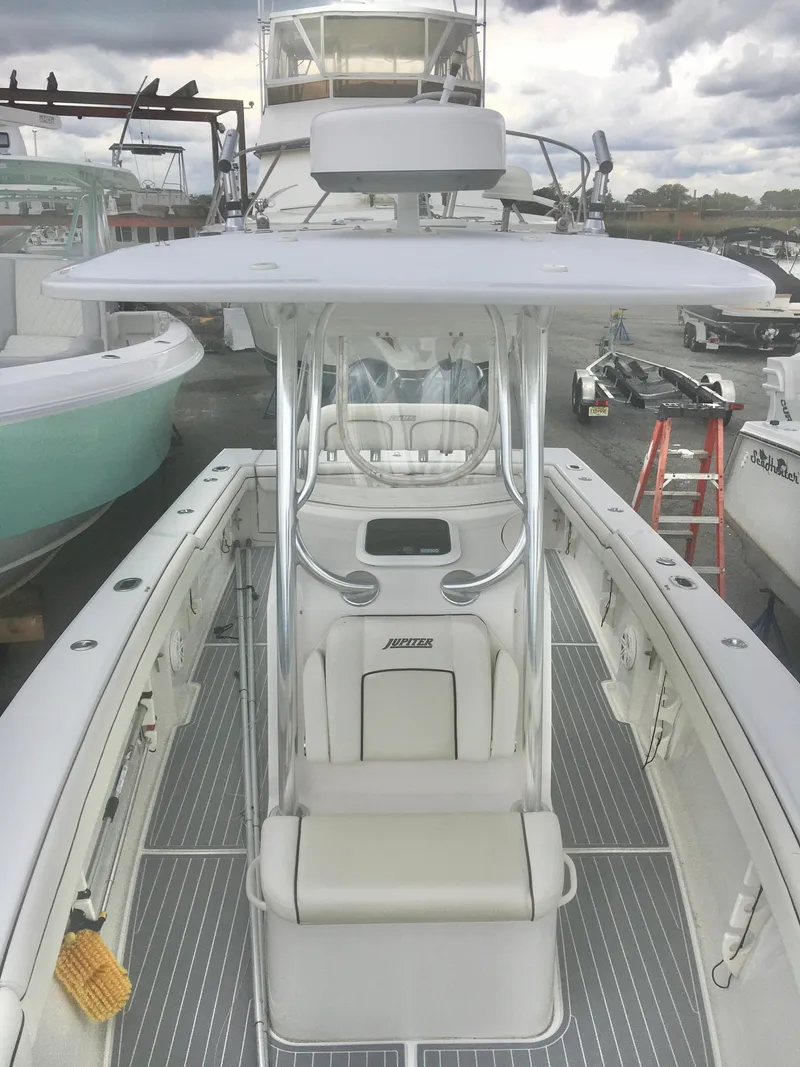 Slide: The Image of 2012 Jupiter 26 Forward Seating boat interior with white cushioned seats and sleek design. - 4