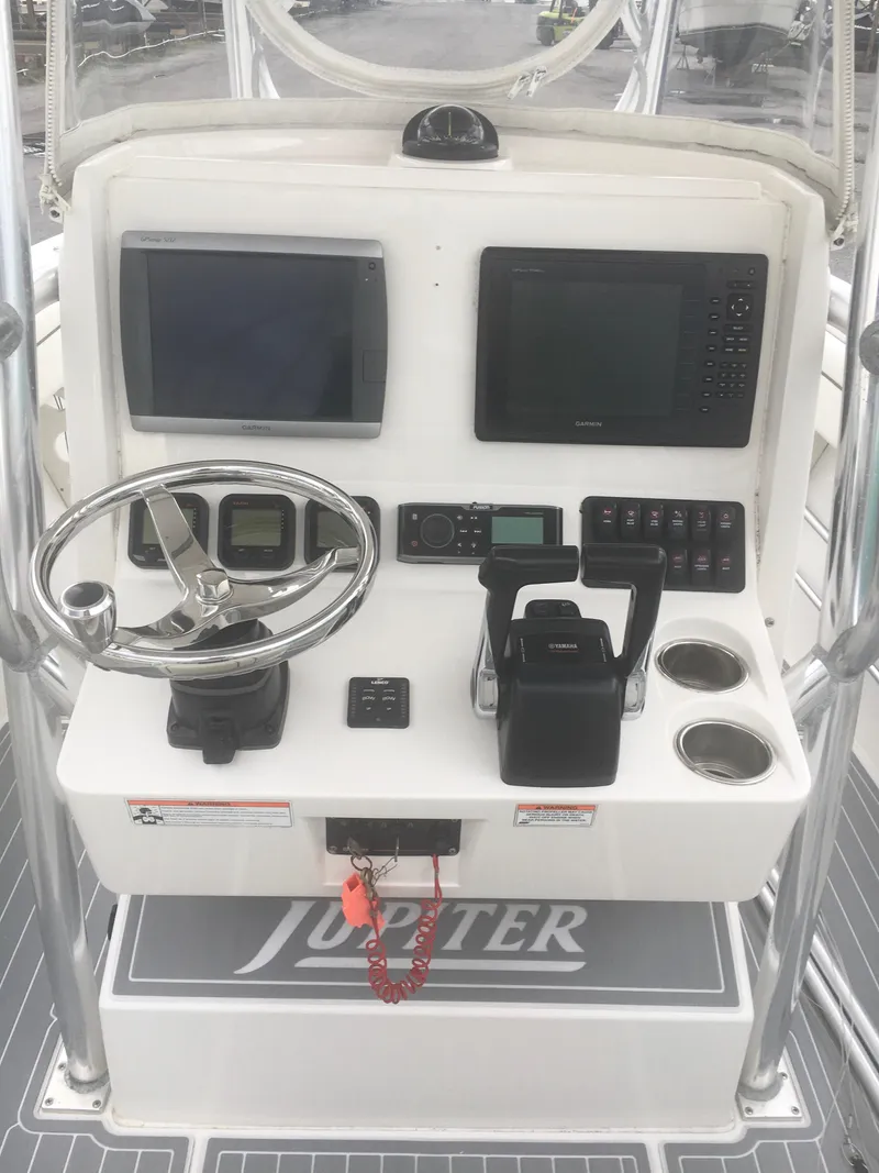 Slide: The Image of 2012 Jupiter 26 Forward Seating boat with white cushioned seats and gray flooring. - 7