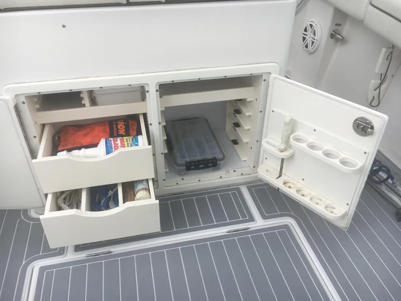 Slide: The Image of 2012 Jupiter 26 Forward Seating boat console with steering wheel and navigation equipment. - 9