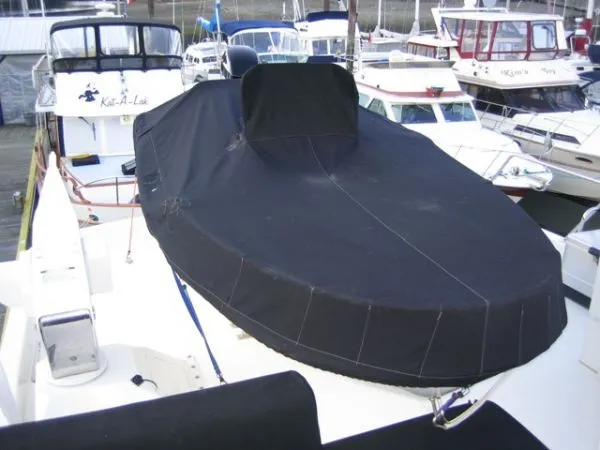 Slide: The Image of 1998 Ocean Alexander Pilothouse Model 584 with water droplets on deck, stored indoors. - 24