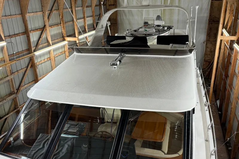 Slide: The Image of 1998 Ocean Alexander Pilothouse Model 584 deck with wood flooring and nautical decor. - 27