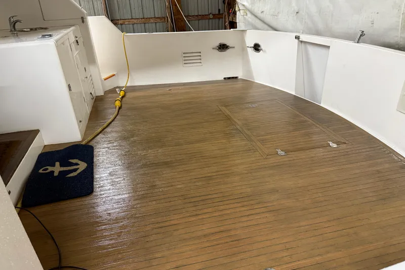 Slide: The Image of 1998 Ocean Alexander Pilothouse Model 584 in a wooden boathouse, showcasing sleek design. - 29