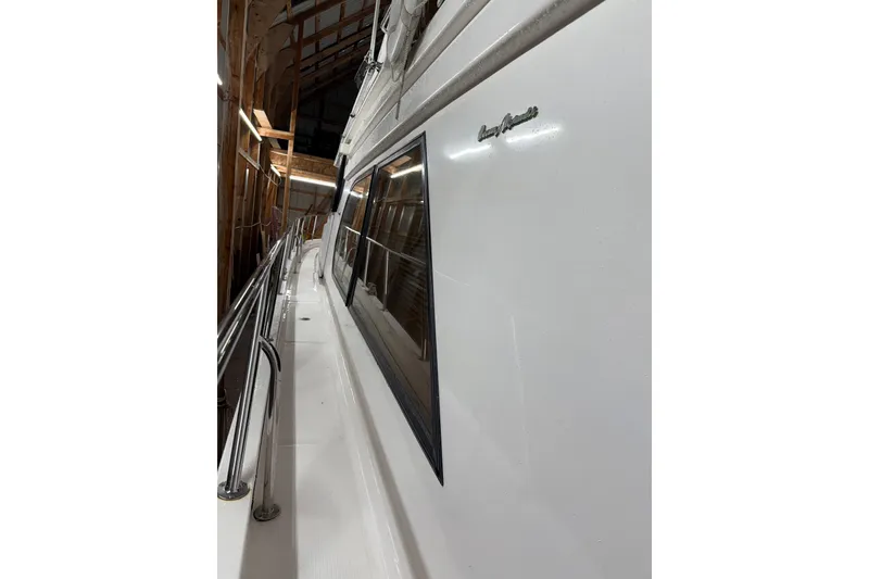 Slide: The Image of 1998 Ocean Alexander Pilothouse Model 584 docked in a covered marina. - 30