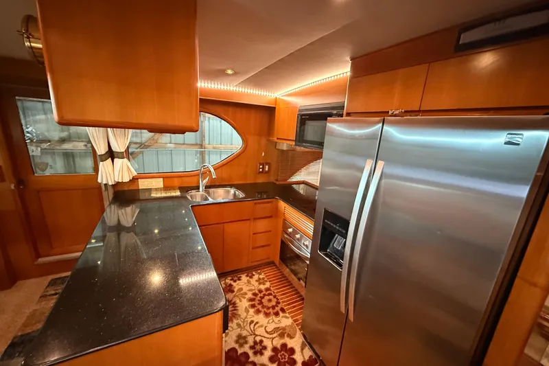 Slide: The Image of 1998 Ocean Alexander Pilothouse Model 584 interior with wooden stairs and cozy seating area. - 40