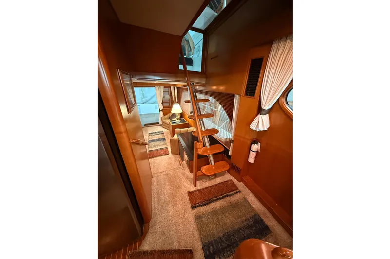 Slide: The Image of Luxurious bedroom in 1998 Ocean Alexander Pilothouse Model 584 yacht, featuring elegant bedding and warm lighting. - 42