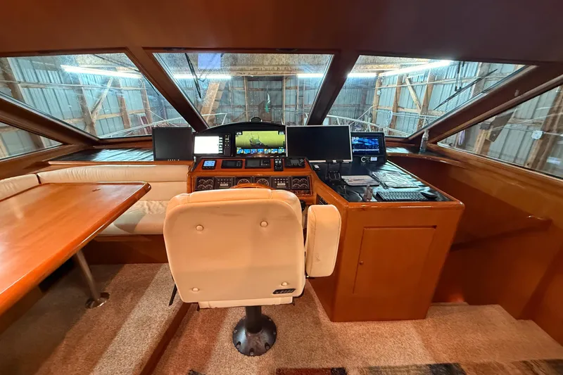 Slide: The Image of Luxurious interior of 1998 Ocean Alexander Pilothouse Model 584 yacht, featuring cozy seating and elegant decor. - 56