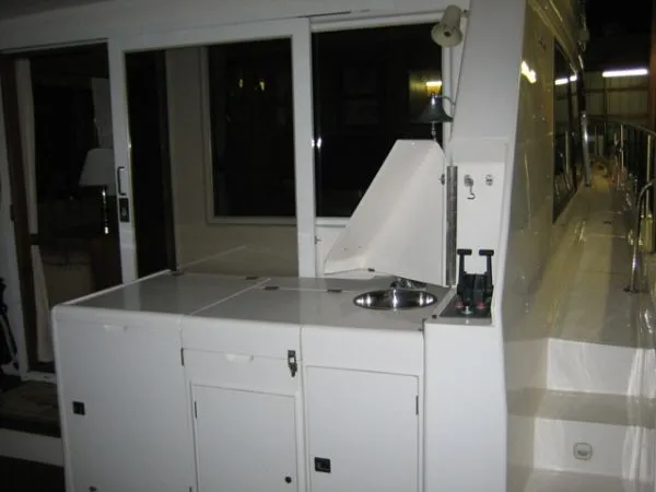 Slide: The Image of 1998 Ocean Alexander Pilothouse Model 584 helm with navigation screens and wooden steering wheel. - 6