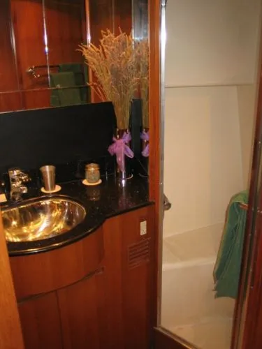 Slide: The Image of 1998 Ocean Alexander Pilothouse Model 584 yacht deck with winch and railing in a workshop. - 22