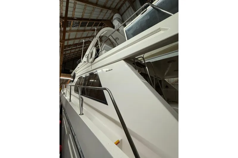Slide: The Image of 1998 Ocean Alexander Pilothouse Model 584, side view in a wooden boathouse. - 28