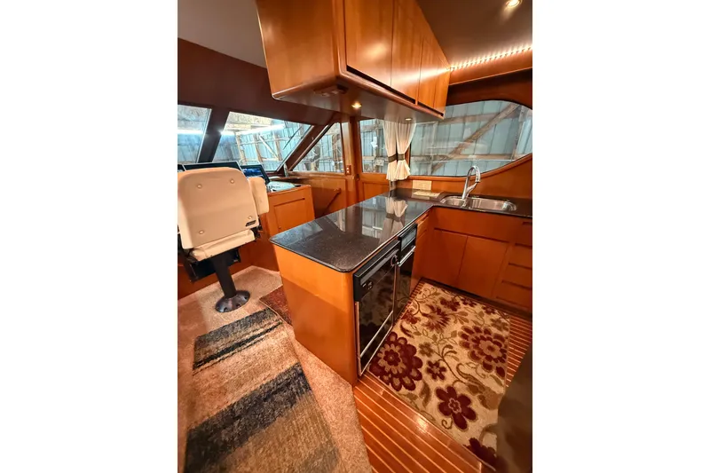 Slide: The Image of 1998 Ocean Alexander Pilothouse Model 584 interior with navigation equipment and seating area. - 41