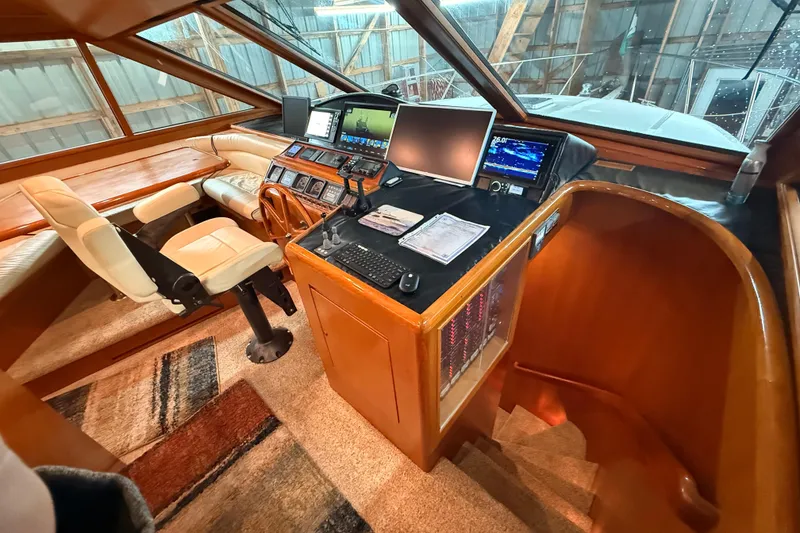 Slide: The Image of Luxurious bedroom in 1998 Ocean Alexander Pilothouse Model 584 yacht, featuring elegant bedding and wood paneling. - 43