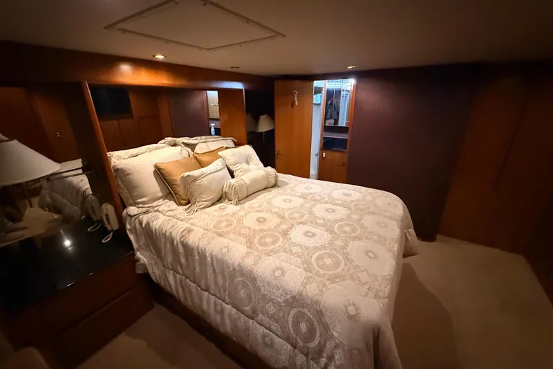Slide: The Image of Luxurious bathroom in 1998 Ocean Alexander Pilothouse Model 584 yacht, featuring wood paneling and modern fixtures. - 45