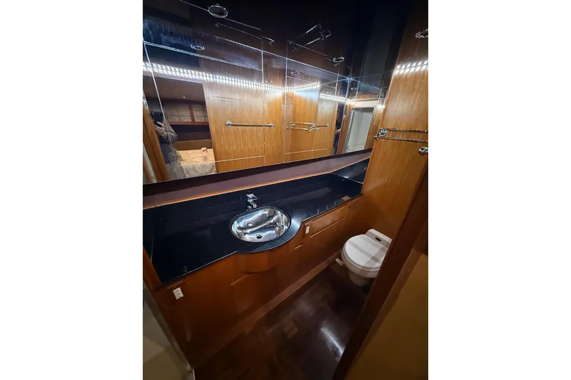 Slide: The Image of Luxurious bathroom in 1998 Ocean Alexander Pilothouse Model 584 yacht, featuring wood accents and modern fixtures. - 48