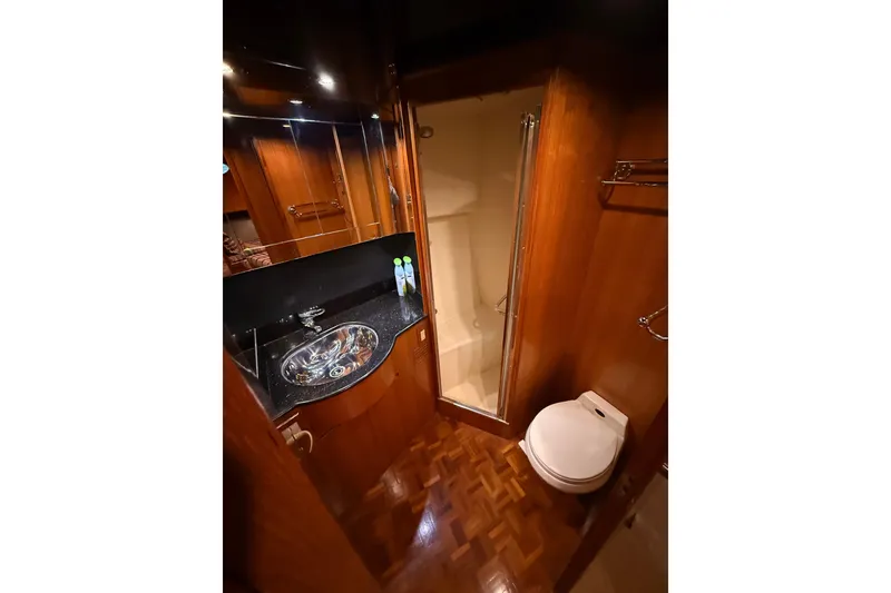 Slide: The Image of 1998 Ocean Alexander Pilothouse Model 584 interior with helm, seating, and wooden table. - 52