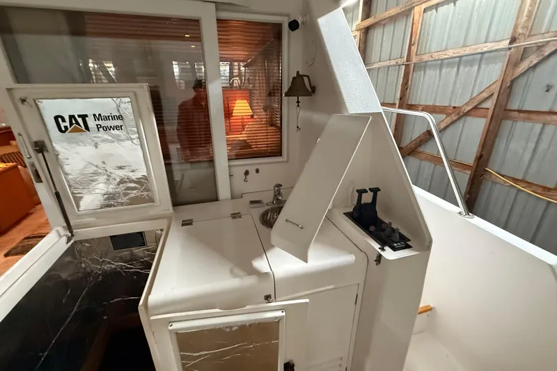 Slide: The Image of 1998 Ocean Alexander Pilothouse Model 584 with Honda outboard motor in storage. - 64